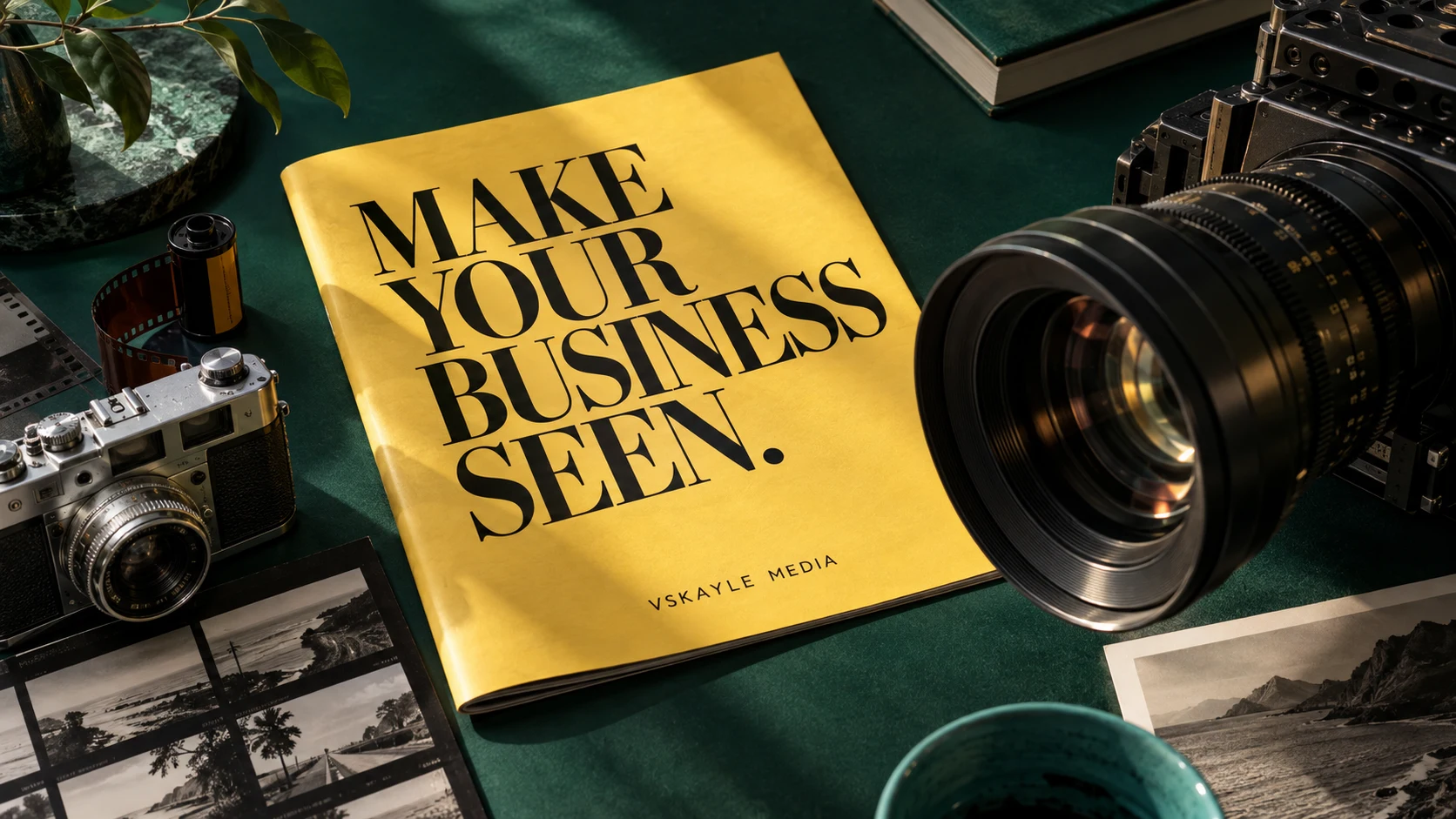VSkayle editorial concept: modern and vintage cameras, film and a yellow magazine reading Make your business seen.